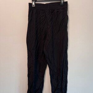 classic black nylon joggers with an elastic waistband and cuffs.